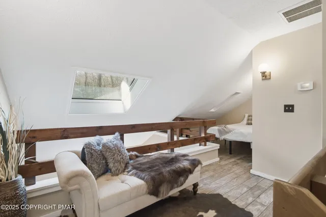 a bedroom with a bed a mirror and a large window