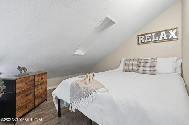 a bedroom with a bed and lamp