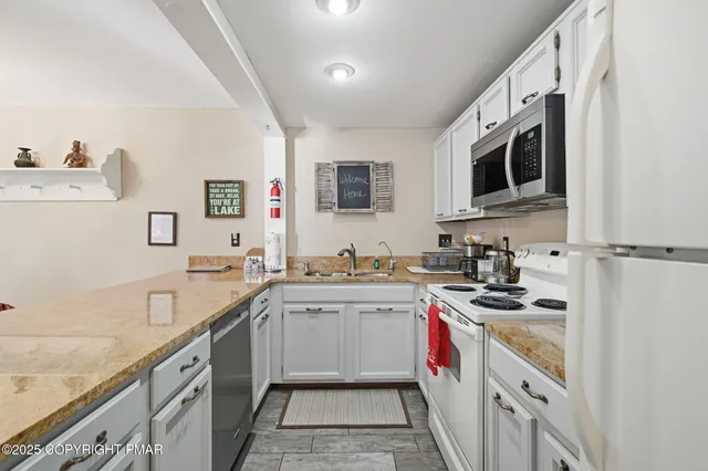 a bedroom with a bed and large windows