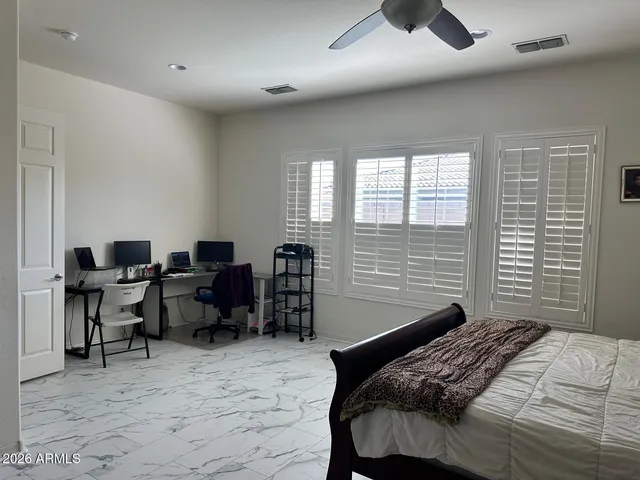 a bedroom that has a bed and a chair in it