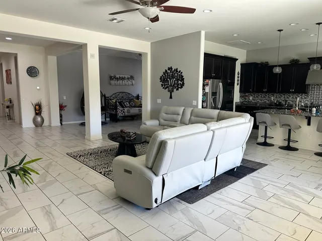 a living room with furniture and a chandelier
