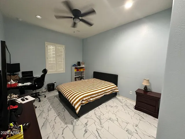 a bedroom with a bed and a tv