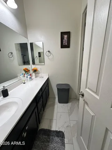 a spacious bathroom with a sink and a mirror