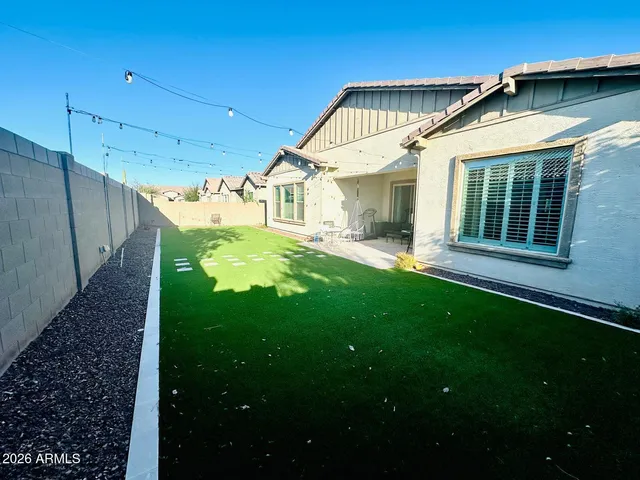 a view of a house with a yard deck and a small cabin
