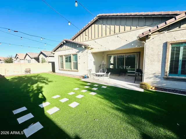 a front view of a house with a garden and patio