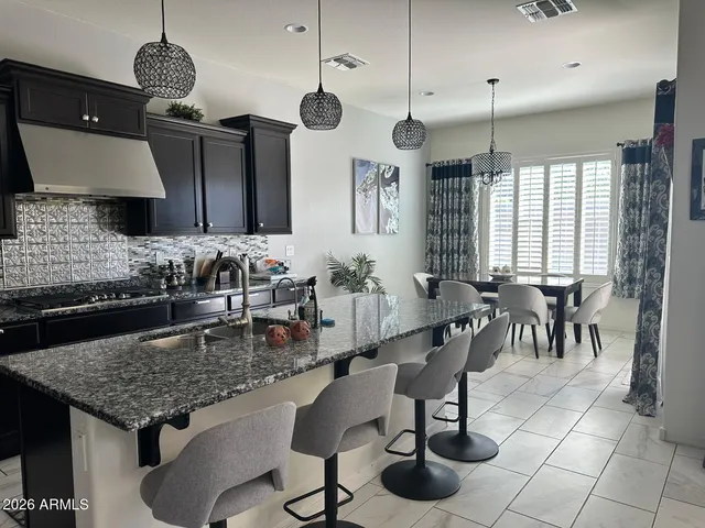 a kitchen with a dining table and chairs