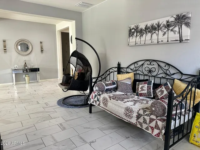 a bedroom with furniture and a mirror