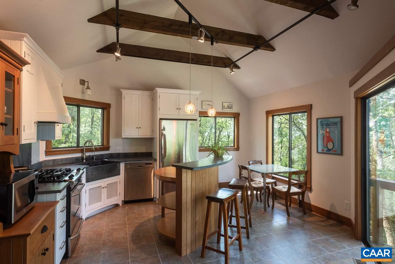 5400 Laurel Ridge Road Charlottesville, VA 22911 - Photo 45 of 49 a kitchen with stainless steel appliances granite countertop a stove a refrigerator a dining table and chairs with wooden floor