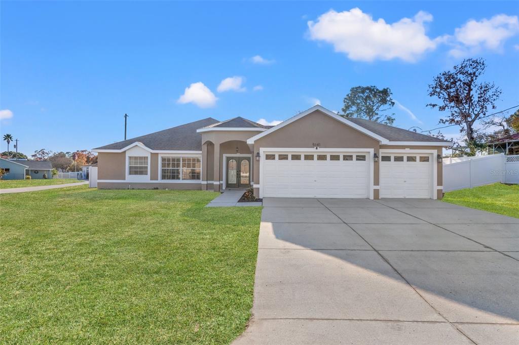 5141 Courtland Road Spring Hill, FL 34608 - Photo 1 of 1 a view of a house with a yard