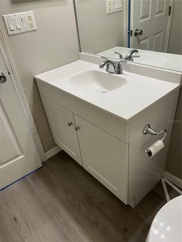 a bathroom with a sink and a mirror