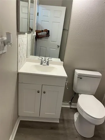 a bathroom with a sink toilet and mirror