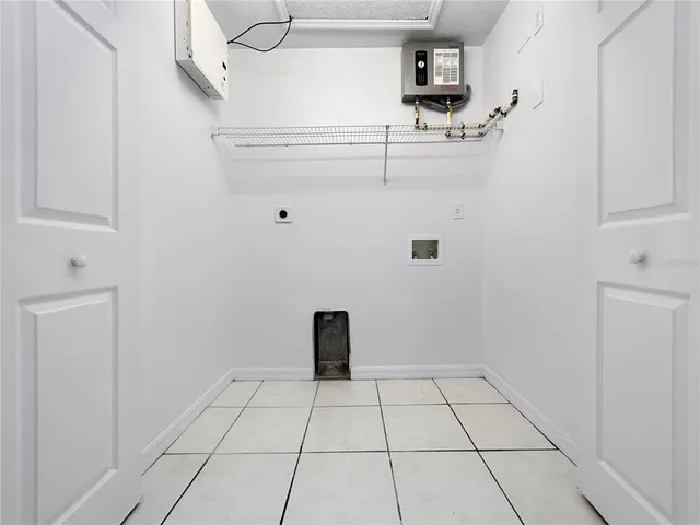 a view of a refrigerator in kitchen and white cabinets