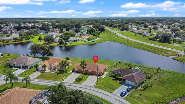 an aerial view of a house with a lake view