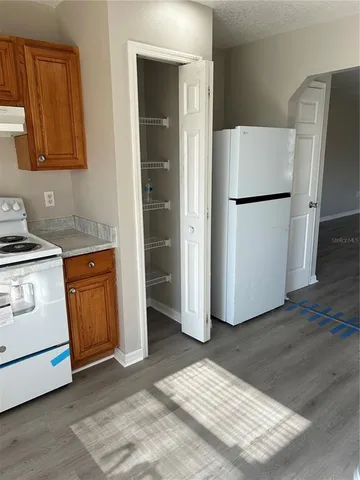 a kitchen with a refrigerator sink and cabinets
