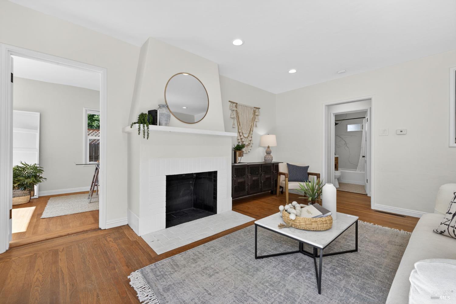 2211 Humboldt Street Santa Rosa, CA 95404 - Photo 7 of 52 a living room with furniture a fireplace and a potted plant