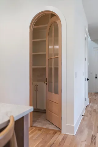 a view of an empty room with wooden floor