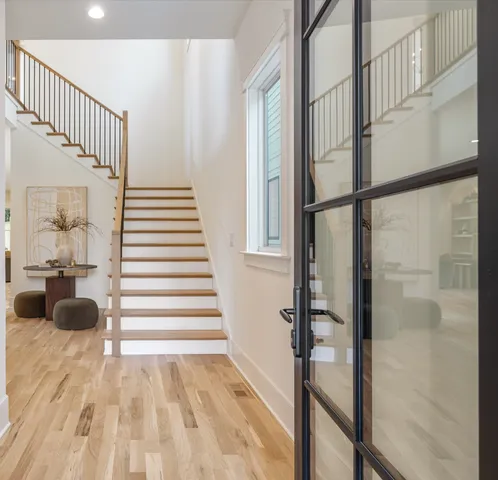 a view of entryway and hall with wooden floor