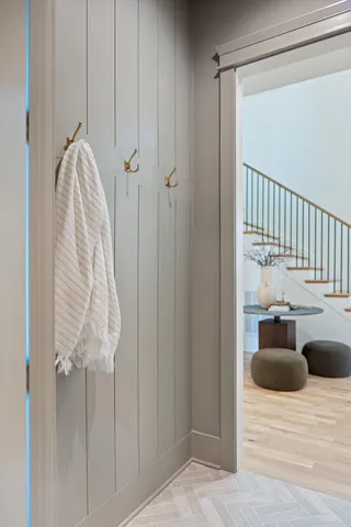 a view of a bedroom with wooden floor and staircase