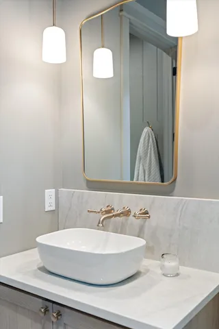 a kitchen with a table chairs and white cabinets
