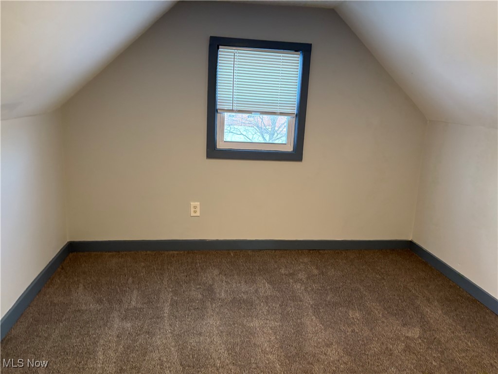 17914 Libby Road Maple Heights, OH 44137 - Photo 8 of 17 Bonus room featuring dark carpet and lofted ceiling