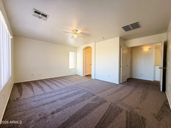 a view of a big room with closet and windows