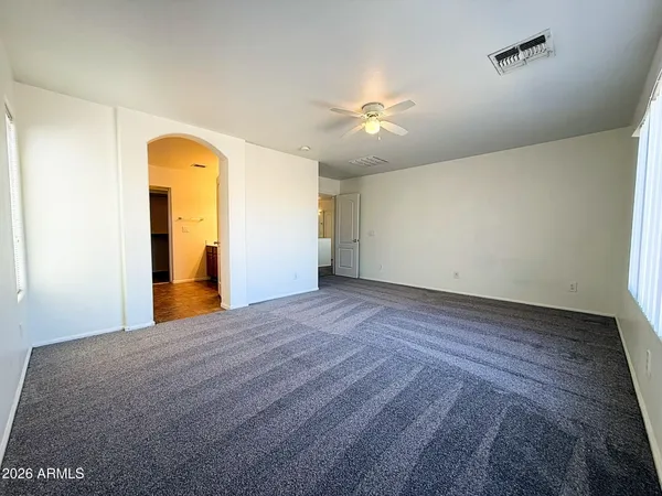 a view of empty room with a fan