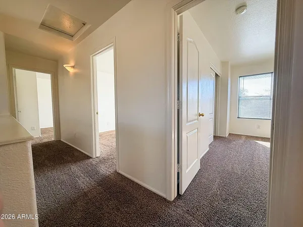 an entryway with a livingroom and a bathroom