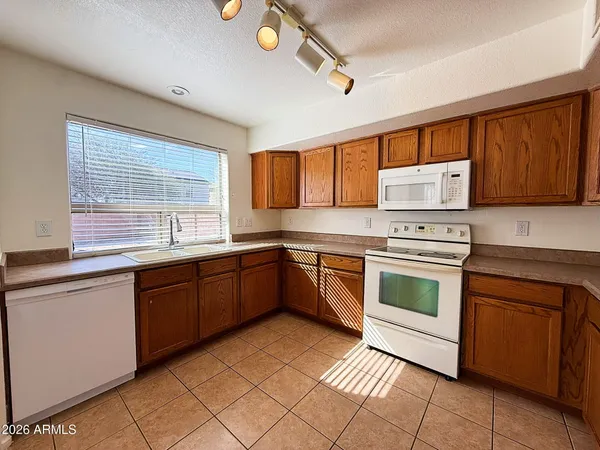 a kitchen with a stove sink and cabinets
