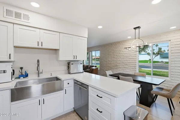 a kitchen with a sink a window and cabinets