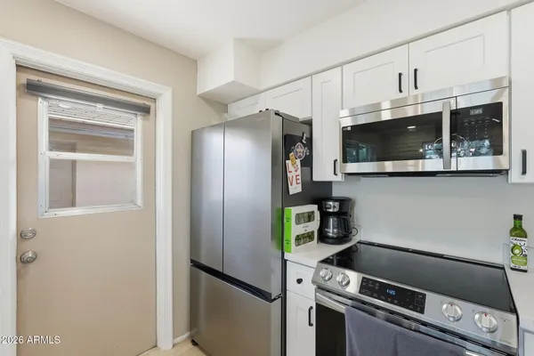 a kitchen with stainless steel appliances a refrigerator a stove a microwave and cabinets