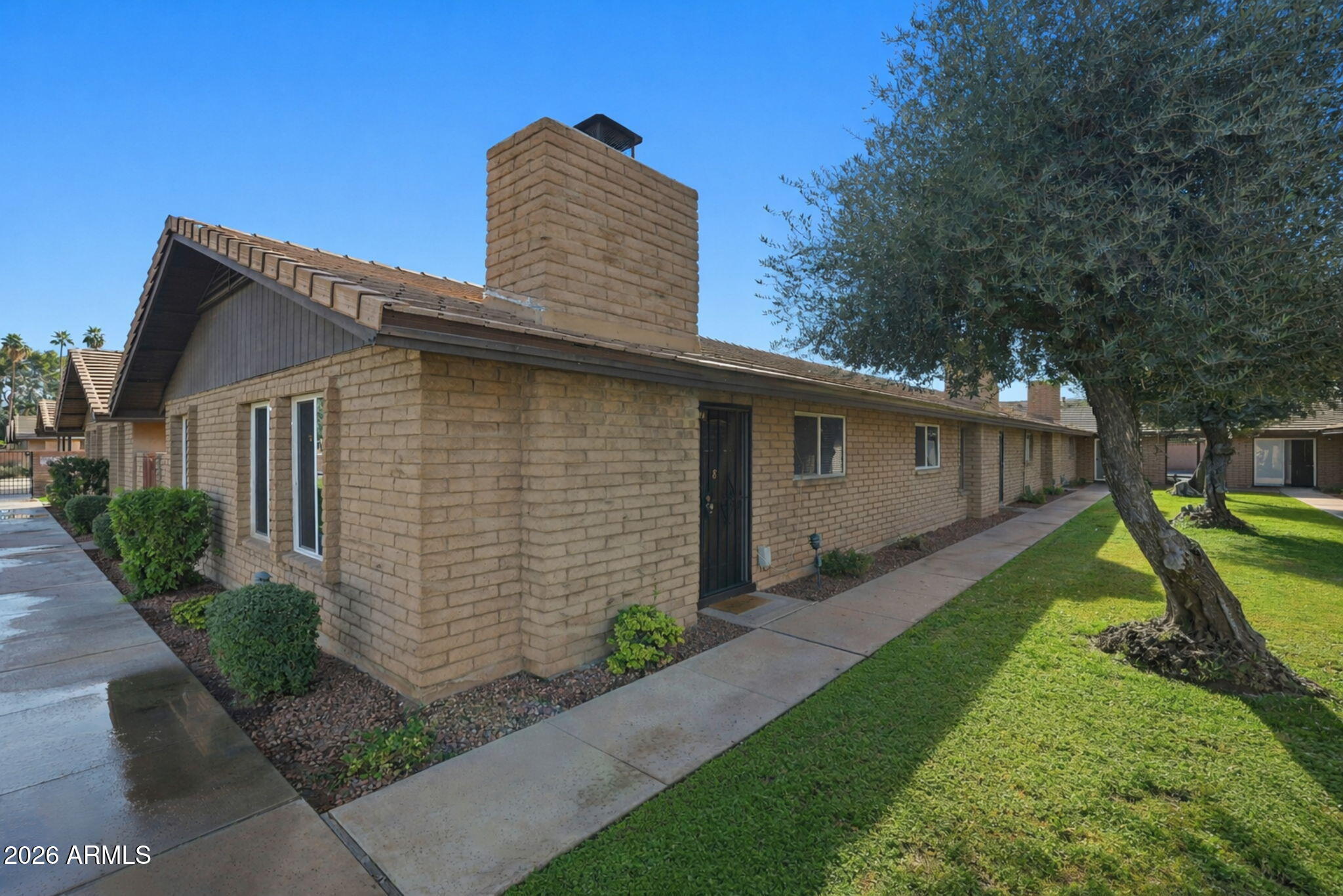 2015 East Southern Avenue, Unit 8 Tempe, AZ 85282 - Photo 2 of 33 a front view of a house with garden