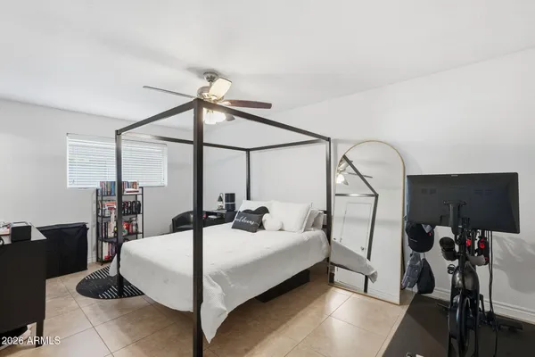 a bedroom with a bed and a mirror