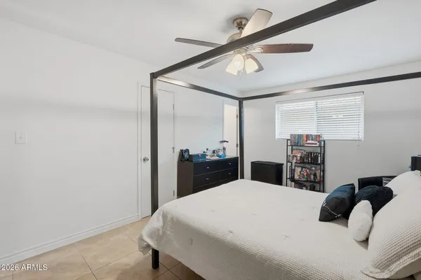 a bedroom with a large bed and a large mirror