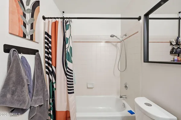 a bathroom with a shower curtain and a bathtub