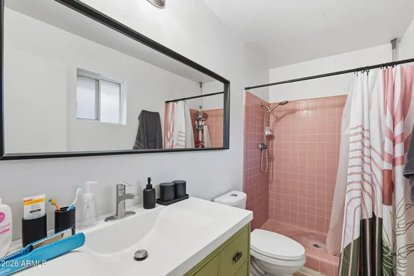 a bathroom with a sink a toilet and shower curtain