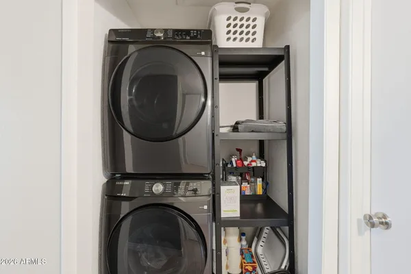 a view of a storage and utility room with washer and dryer