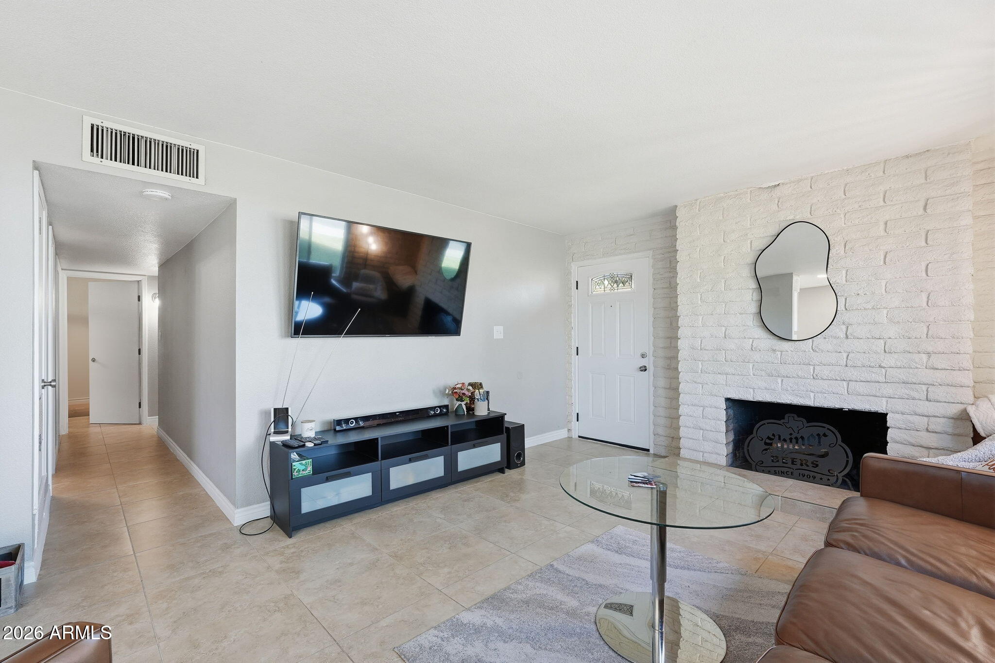 2015 East Southern Avenue, Unit 8 Tempe, AZ 85282 - Photo 7 of 33 a living room with furniture a fireplace and a flat screen tv