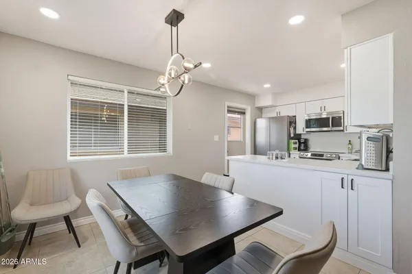 a living room with stainless steel appliances kitchen island granite countertop furniture and a kitchen view