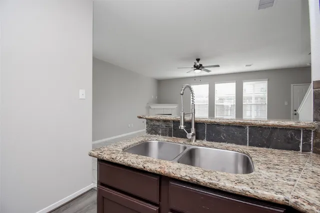 a kitchen with granite countertop a sink and a window