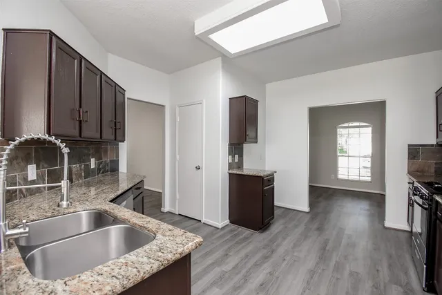 a kitchen with a sink and a refrigerator
