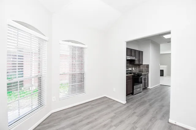 a view of wooden floor and windows in a room