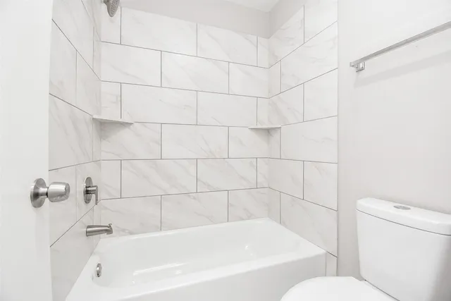 a bathroom with a bathtub and toilet