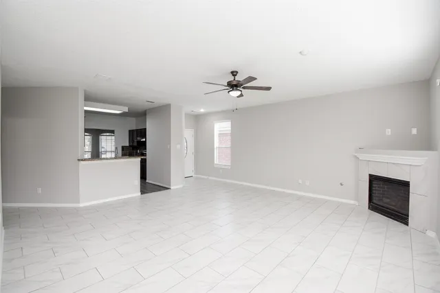 a view of a kitchen with a sink and a fireplace