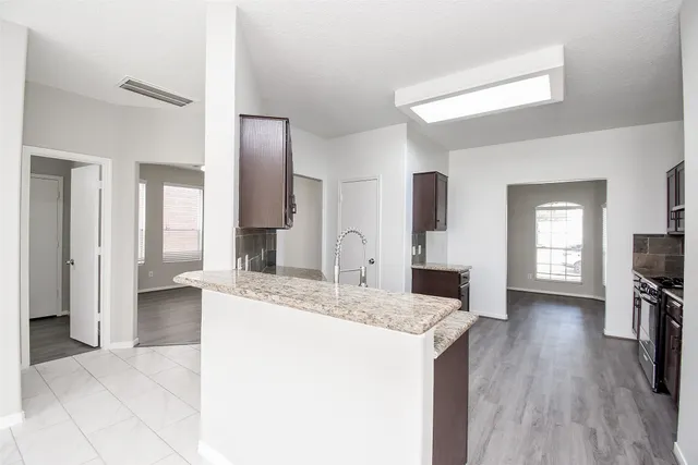 a view of living room with granite countertop furniture and fireplace