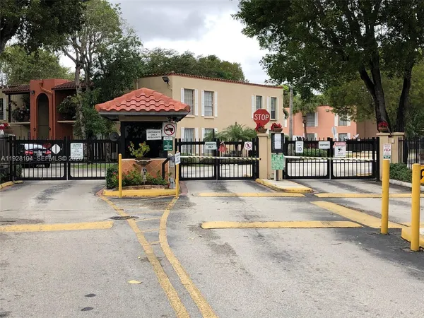 a view of a park with iron fence