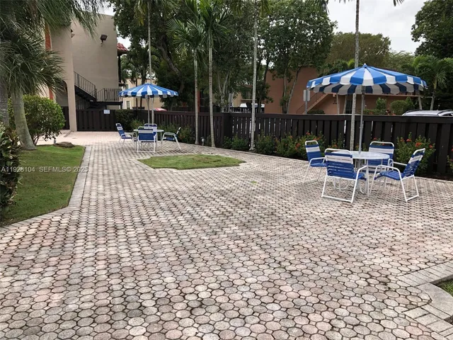 a view of a patio with a yard