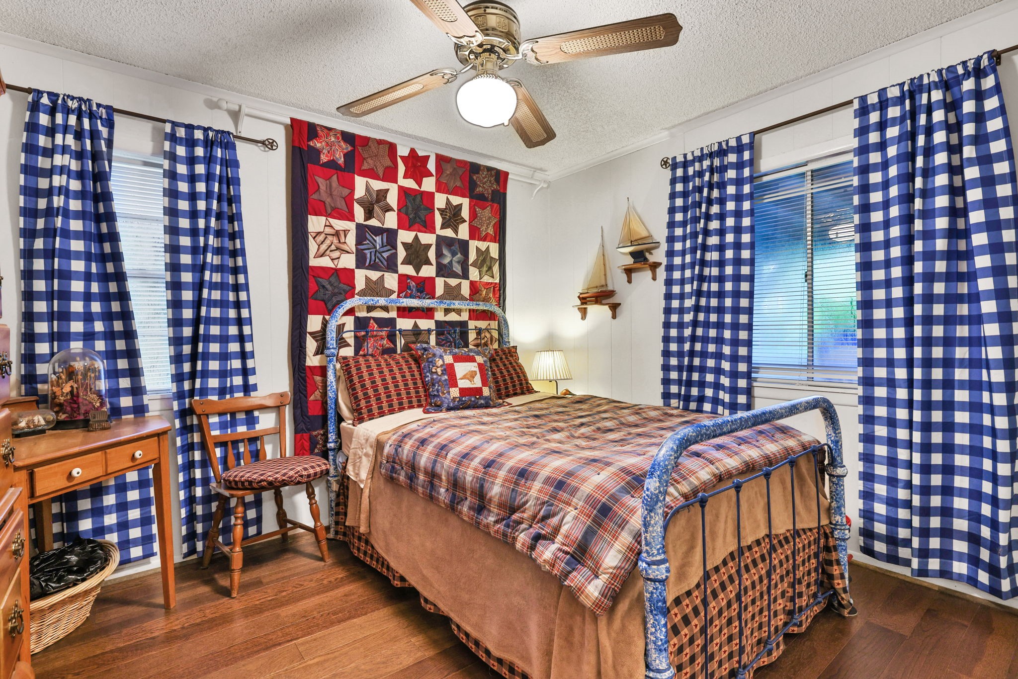 300 Timber Lane Coldspring, TX 77331 - Photo 18 of 43 a bedroom with a bed and dresser with wooden floor