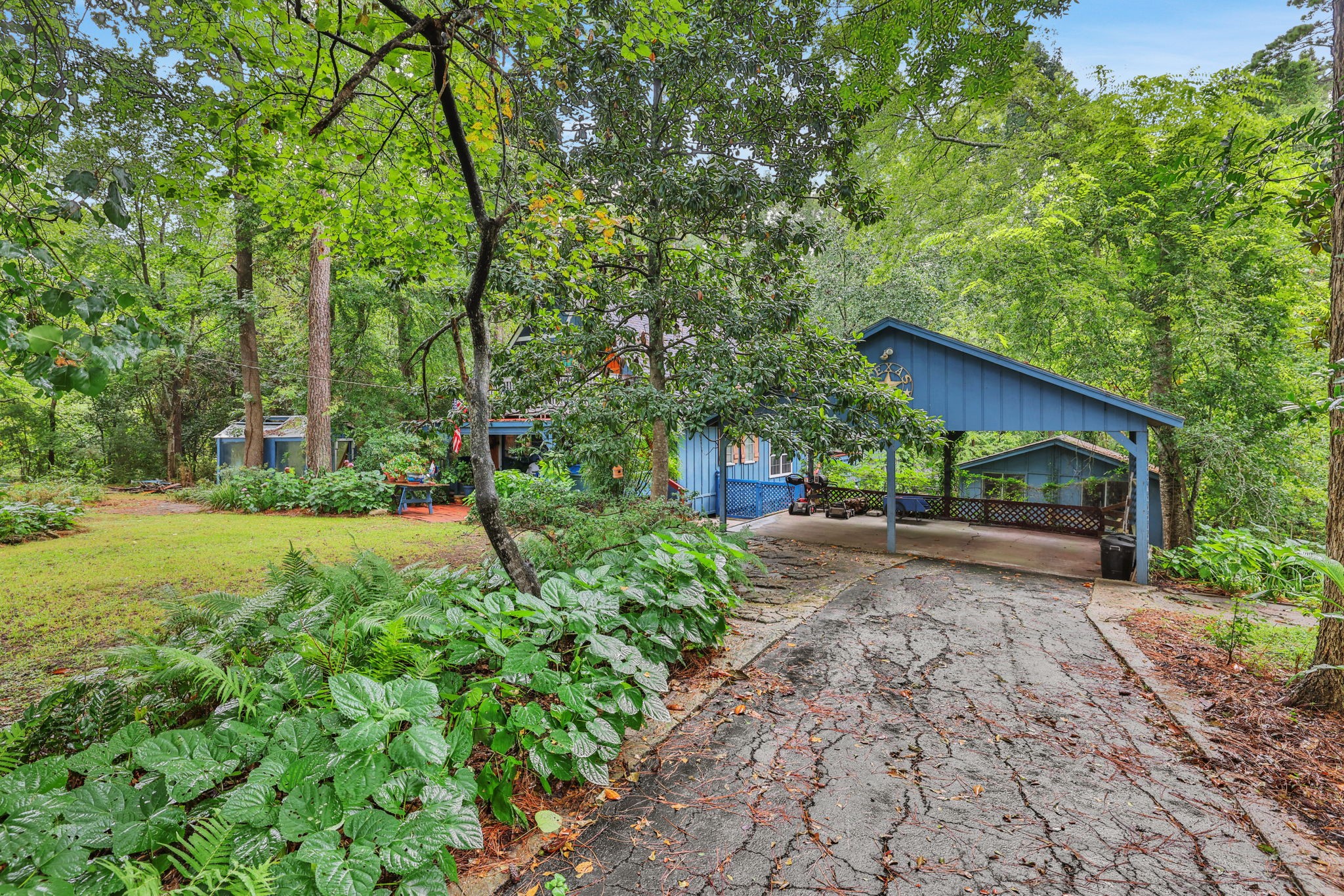 300 Timber Lane Coldspring, TX 77331 - Photo 2 of 43 a front view of a house with garden