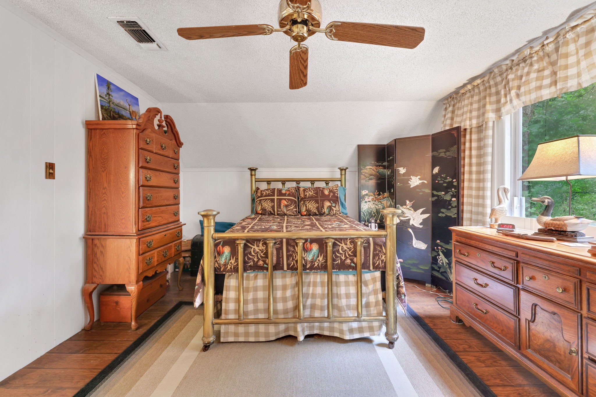 300 Timber Lane Coldspring, TX 77331 - Photo 22 of 43 a bedroom with a bed and wooden floor
