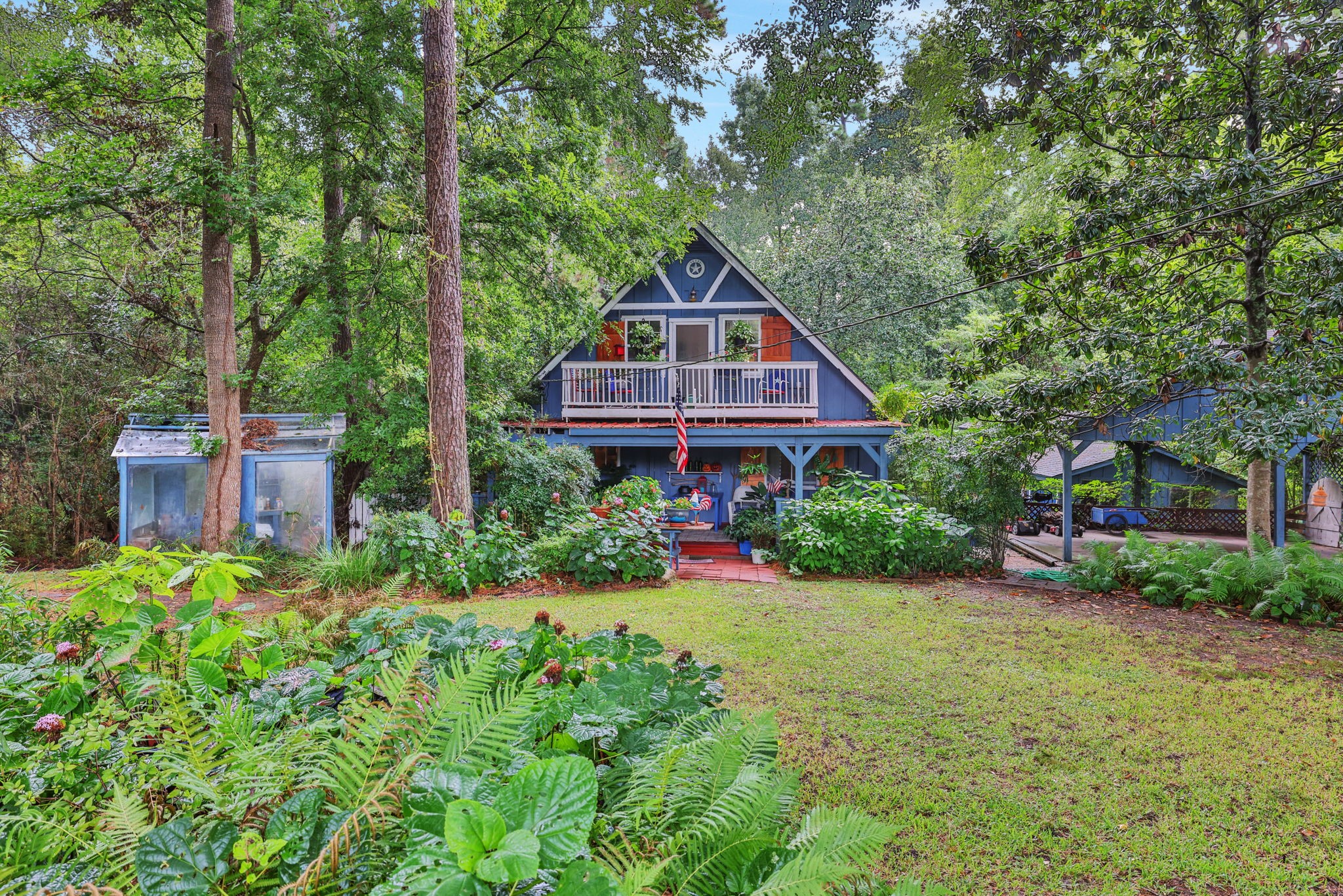 300 Timber Lane Coldspring, TX 77331 - Photo 3 of 43 a house view with a garden space